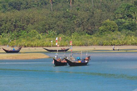 Fishing boats on the lagoon of Tizit beach on the Dawei peninsula, Myanmarの写真素材