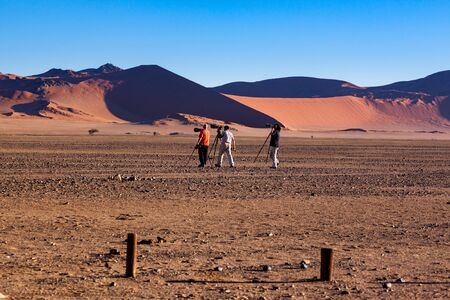 Sossusvlei, Namibia, May 11 2005 - Photographers taking dune 45 sunset shot