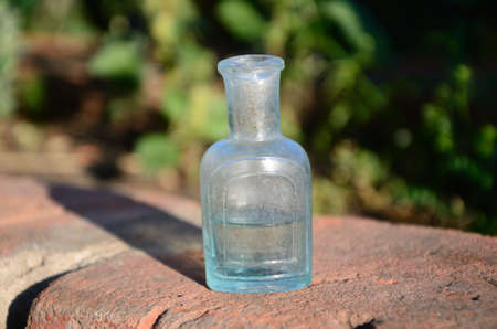 Macrophoto of an ancient small glass bottleの写真素材