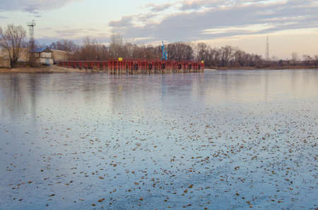 First ice at the dock covered with autumn leaves.の写真素材