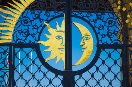 The metal gate of the tower Syuyumbike with a golden sun and moon. Historic and Architectural Complex of the Kazan Kremlin.  Kazan, Republic of Tatarstan, Russia.の写真素材