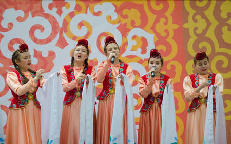 Kazan, Republic of Tatarstan, Russia - May 28, 2016: Girls in national Tatar costumes sing a song. Sabantuy (translated from Tatar - feast of the plow) is a traditional celebration of the end of spring field work.のeditorial素材