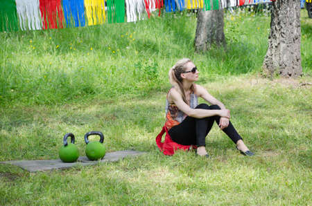 Kazan, Republic of Tatarstan, Russia - May 28, 2016: The girl sitting next to the kettlebell. Sabantuy (translated from Tatar - feast of the plow) is a traditional celebration of the end of spring field work.のeditorial素材