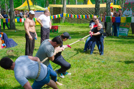 Kazan, Republic of Tatarstan, Russia - May 28, 2016: Competitions in tug of war among men. Sabantuy (translated from Tatar - feast of the plow) is a traditional celebration of the end of spring field work.のeditorial素材