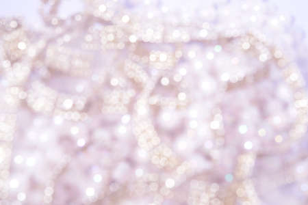 Festive gold Christmas background. Circles bokeh or particles. Golden sparkles or glitter lights. Template backdrop for design.の写真素材