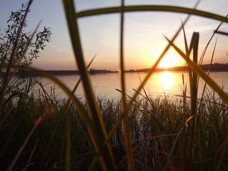 Sunset above the lake in summer dayの写真素材