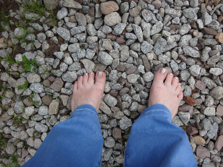 Woman's legs on the ground in summer dayの写真素材
