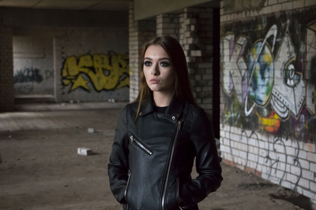 Beautiful teenager girl in a dark hallwayの写真素材