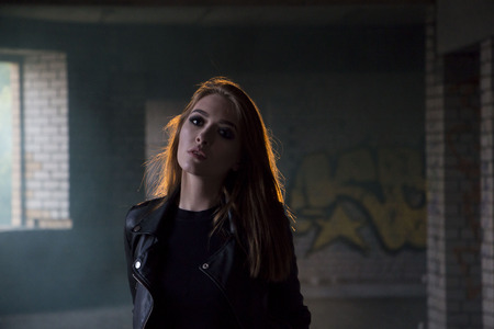 Beautiful teenager girl in a dark hallway