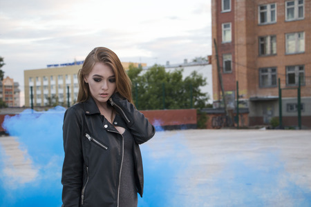 Girl on the roof and smoke aroundの写真素材