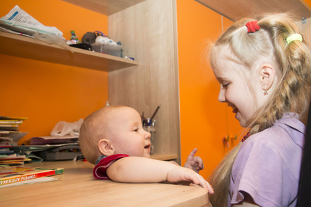 Young girl and her brother in the roomの写真素材