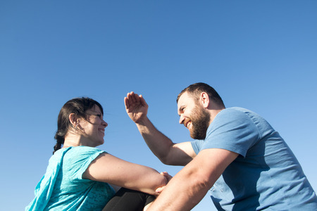 Brutal man and nice woman rest together outdoorの写真素材
