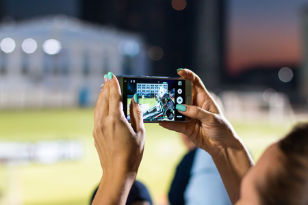Russia, Kirov - August, 09, 2016: Spectators are taking pictures of extreme auto show in Kirov city in 2016のeditorial素材