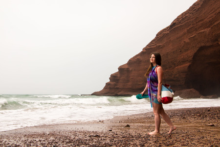 Girl, beach and sea in cloudy and foggy dayの写真素材