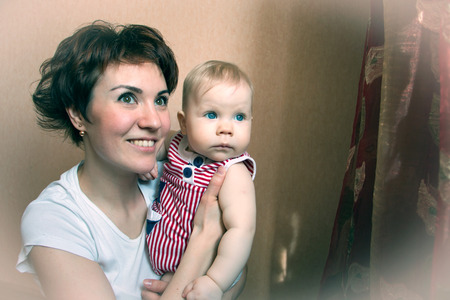 Small cute baby and mom in the roomの写真素材