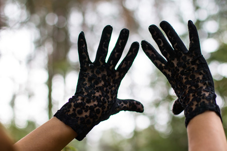 Hands in black gloves and nature aroundの写真素材