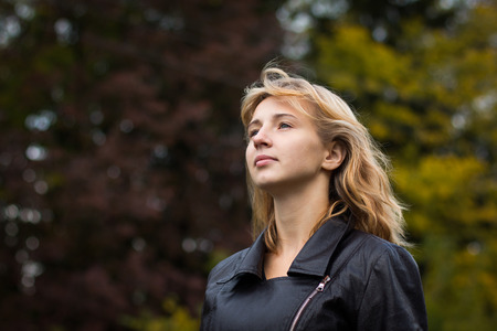 Nice girl outdoor in an autumn dayの写真素材