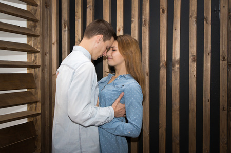 Beautiful couple in a room lined with woodの写真素材