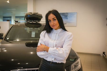 Nice girl in a shop selling car
