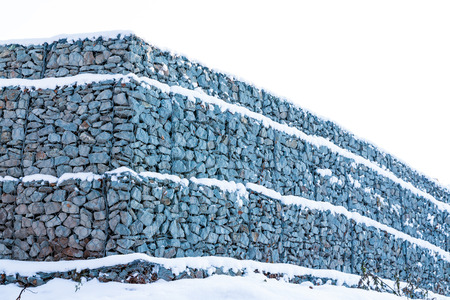 Wall is made by grey stone in a winter dayの写真素材