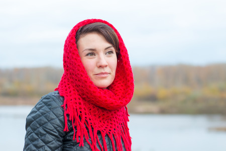 Nice girl in red scarf outdoor in autumn dayの写真素材
