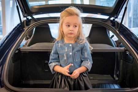 Small girl in exhibition room for carの写真素材