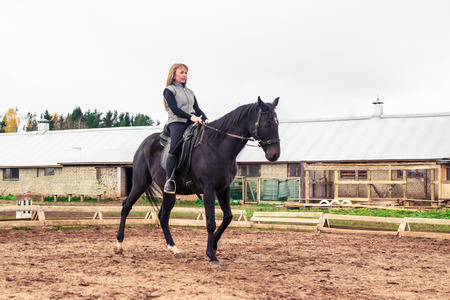 Girl and horse in an autumn dayの写真素材