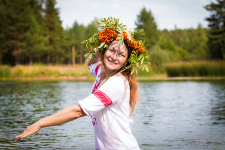 Pretty girl in national dress is in waterの写真素材