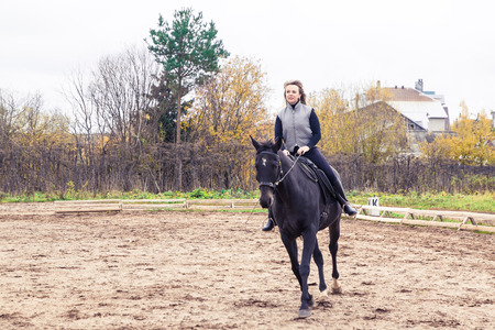 Girl and horse in an autumn dayの写真素材