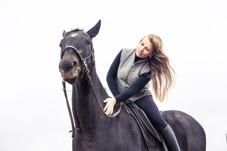 Girl and horse in an autumn dayの写真素材