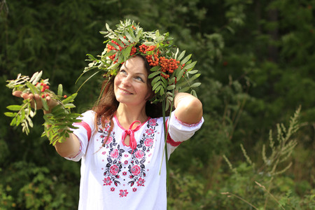Pretty girl in national dress in a forestの写真素材