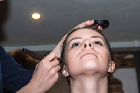 Make-up artist doing the make-up for beautiful girlの写真素材