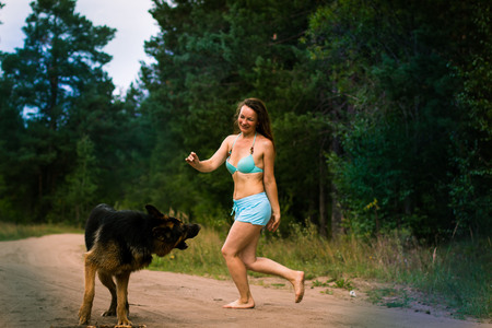 Pretty girl and dog German shepherd outdoorの写真素材
