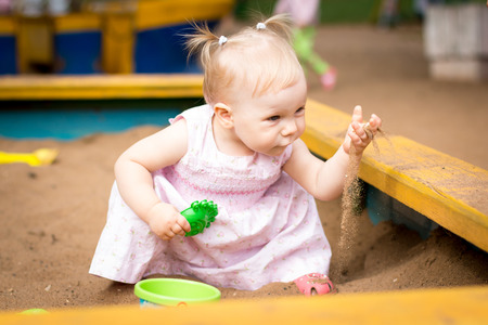 Small cute baby outdoors in the parkの写真素材