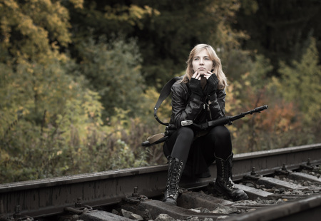 Girl with arms on the rails in autumn dayの写真素材