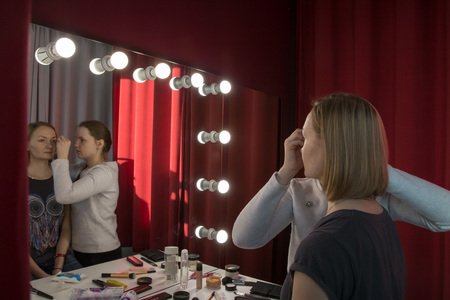 Make-up artist doing the make-up for nice girlの写真素材