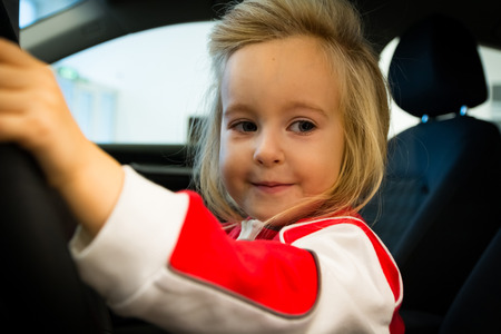 Small girl in exhibition room for carの写真素材
