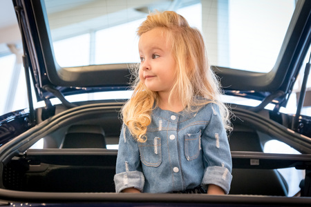 Small girl in exhibition room for carの写真素材