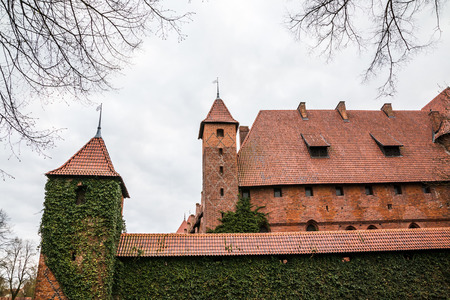 Big beautiful castle made of red brick and cloudy skyの写真素材