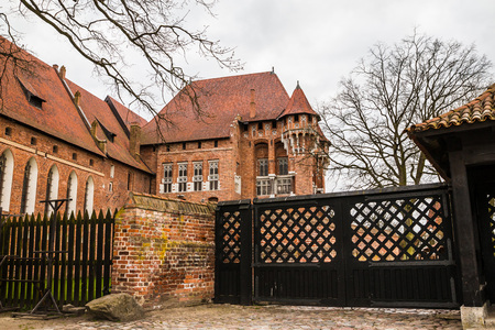 Big beautiful castle made of red brick and cloudy skyの写真素材