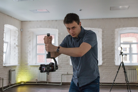 Russia, Kirov - March, 07, 2017: Guy shoots video and photos of a rehearsal dance at the athletic...