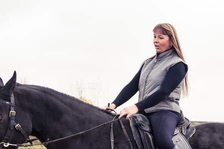Girl and horse in an autumn dayの写真素材