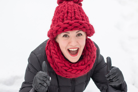 Cute girl in a warm hat in winter dayの写真素材