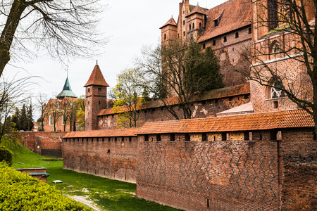 Big beautiful castle made of red brick and cloudy skyの写真素材