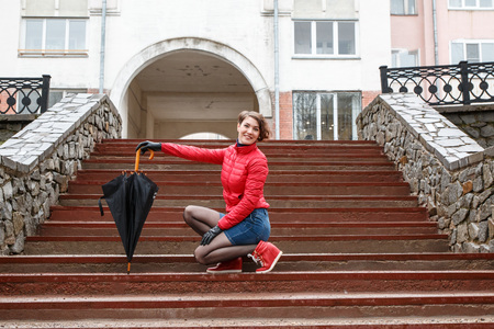Girl with umbrella outdoor in a raining dayの写真素材