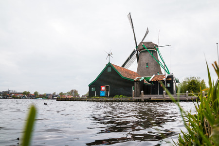 Netherlands, Zaanse Schans - April, 24, 2017: Windmill and the landscape around in a cloudy day in Zaanse Schans in 2017のeditorial素材