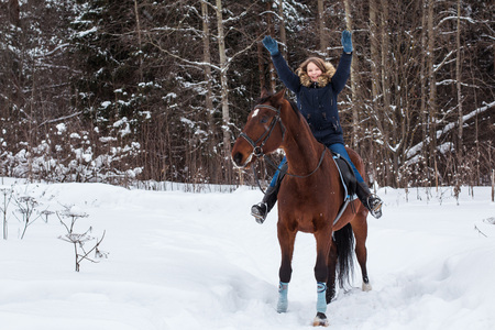Girl teenager and big horse in a winter dayの写真素材