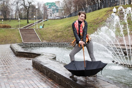 Girl with umbrella outdoor in a raining day  の写真素材