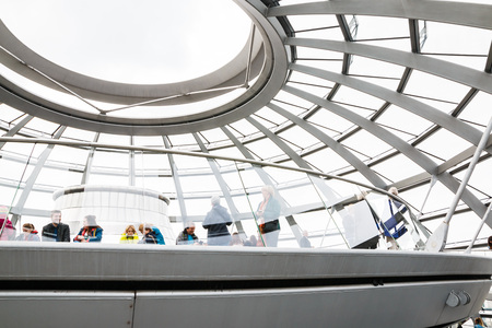 Germany, Berlin - April, 21, 2017: The glass dome of the Reichstag and the people in it in Berlin in...