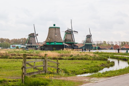 Netherlands, Zaanse Schans - April, 24, 2017: Windmill and the landscape around in a cloudy day in Zaanse Schans in 2017のeditorial素材